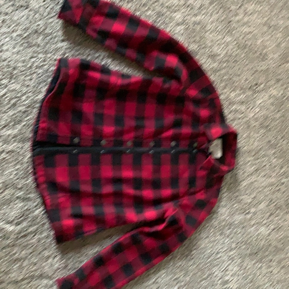 Buffalo plaid heavy cotton with black fleece lining. 2 front pockets.